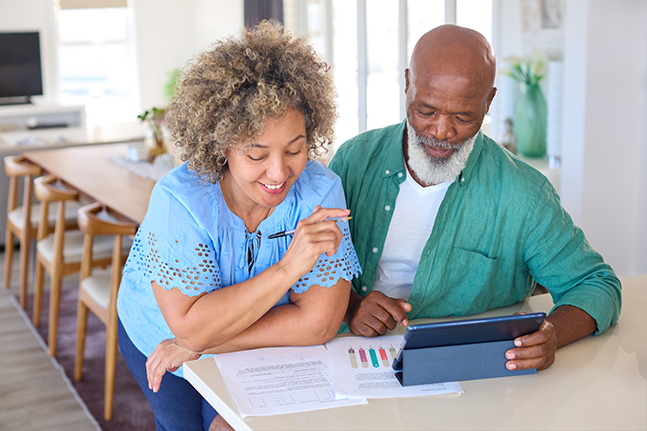 woman and man reviewing paperwork and charts