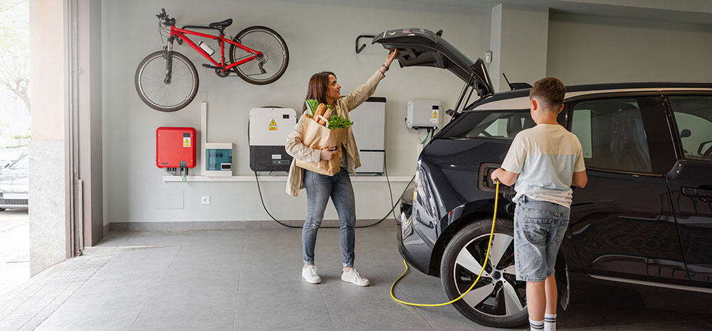 Stock photo of family charging vehicle using at home charger
